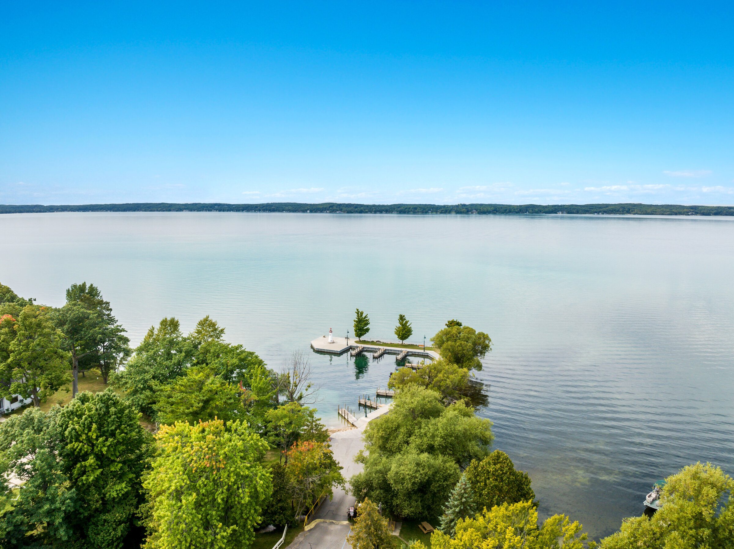 Aerial view of the wooded Torch Lake shoreline, homes and docks