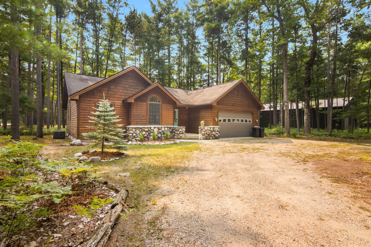 A real My Torch Lake log cottage surrounded by pines