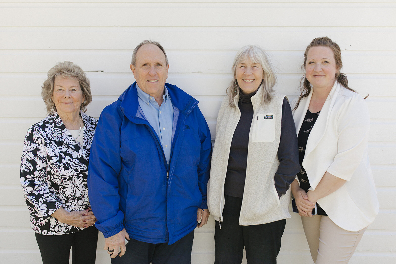 Four members of the Paradise Properties USA team standing together outdoors